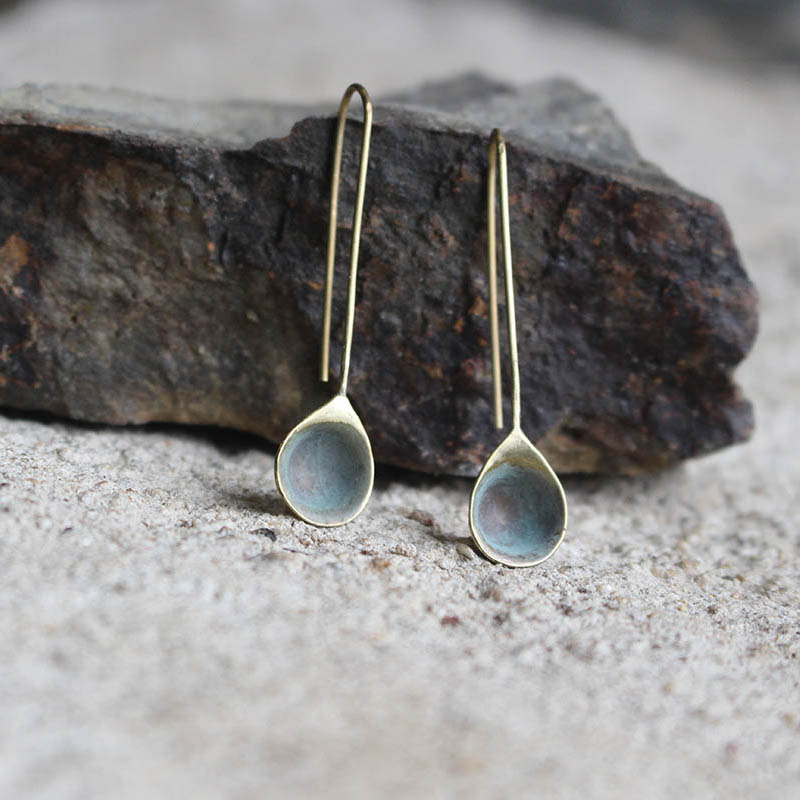 Boucles d’oreilles gouttelettes d'eau, en laiton fabriquées artisanalement par les Métalleuses en fusion. Vue posées.